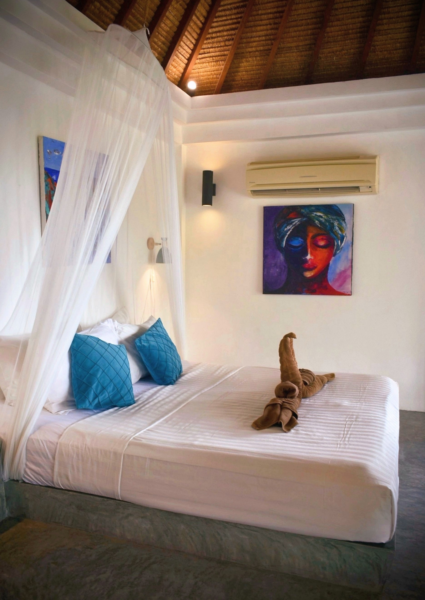 Bedroom with canopy bed and artwork in The Sailfish House