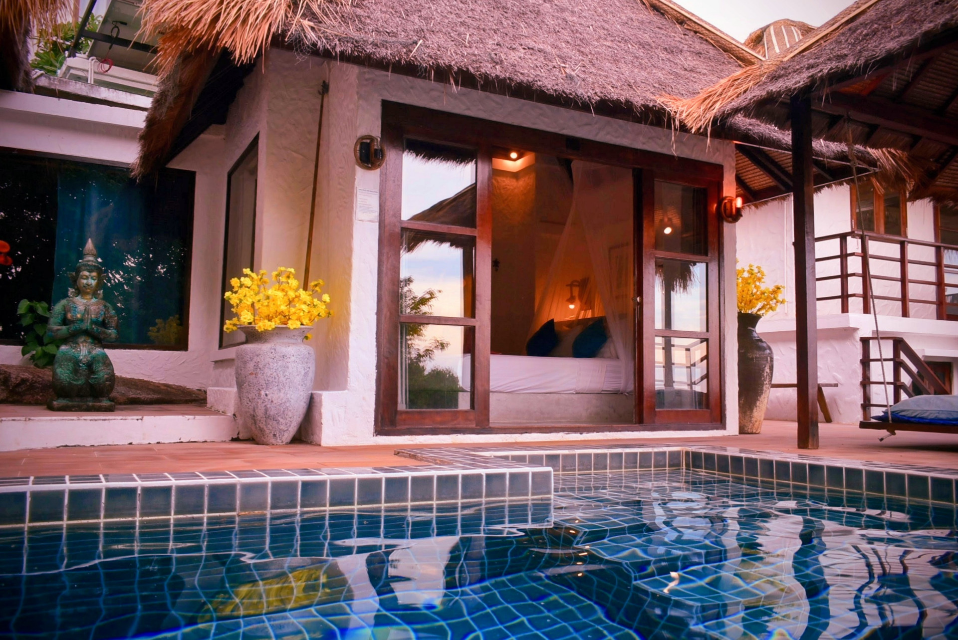 Private pool and bedroom of The Fisherman’s House at sunset