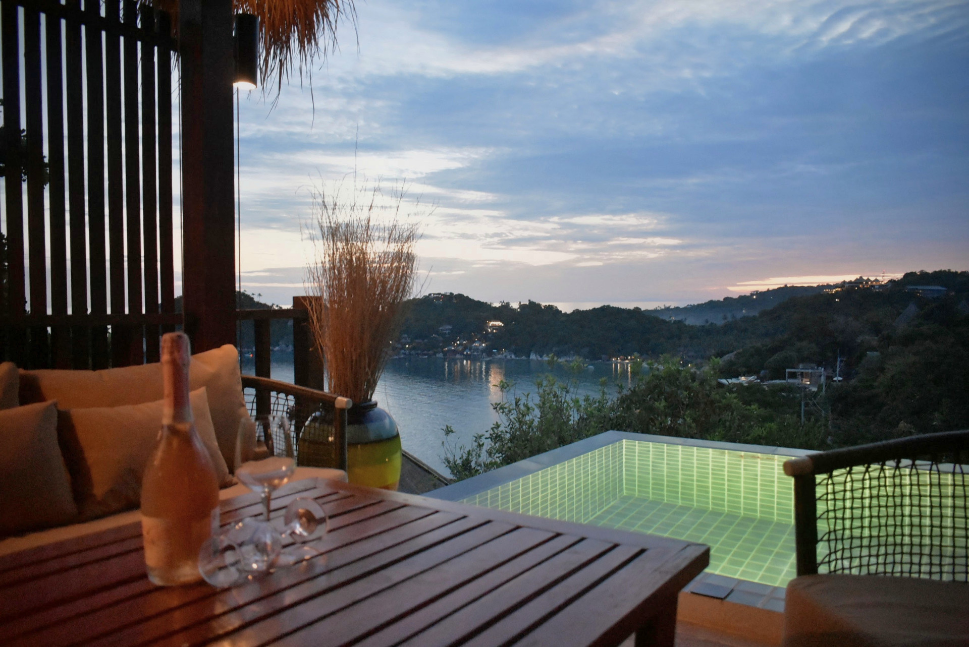 Sunset terrace dining beside the lit pool at The Red Snapper House