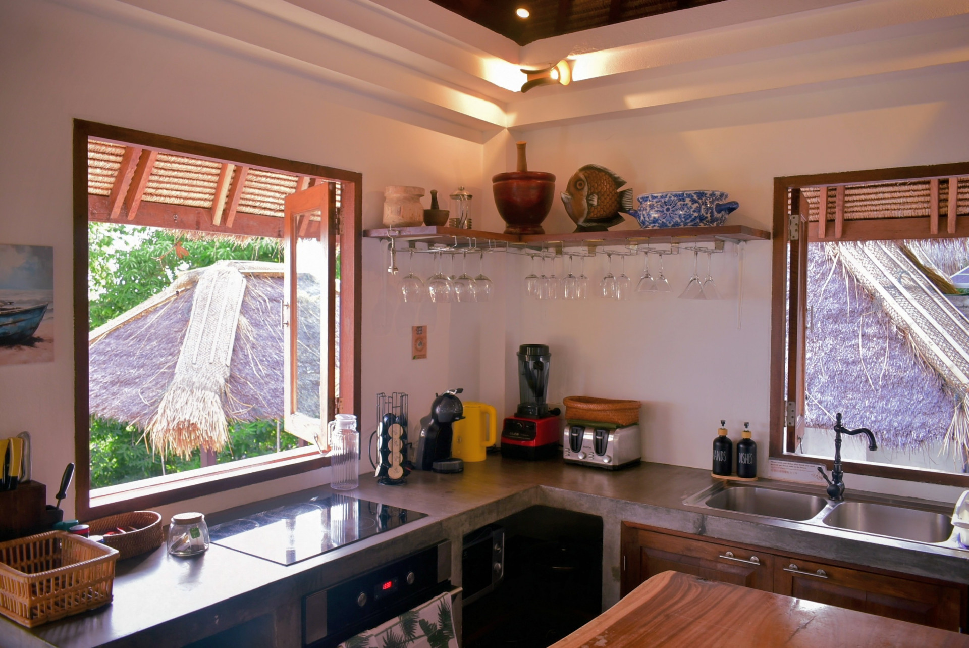 Kitchen with garden-view windows and induction hob at The Fisherman’s House