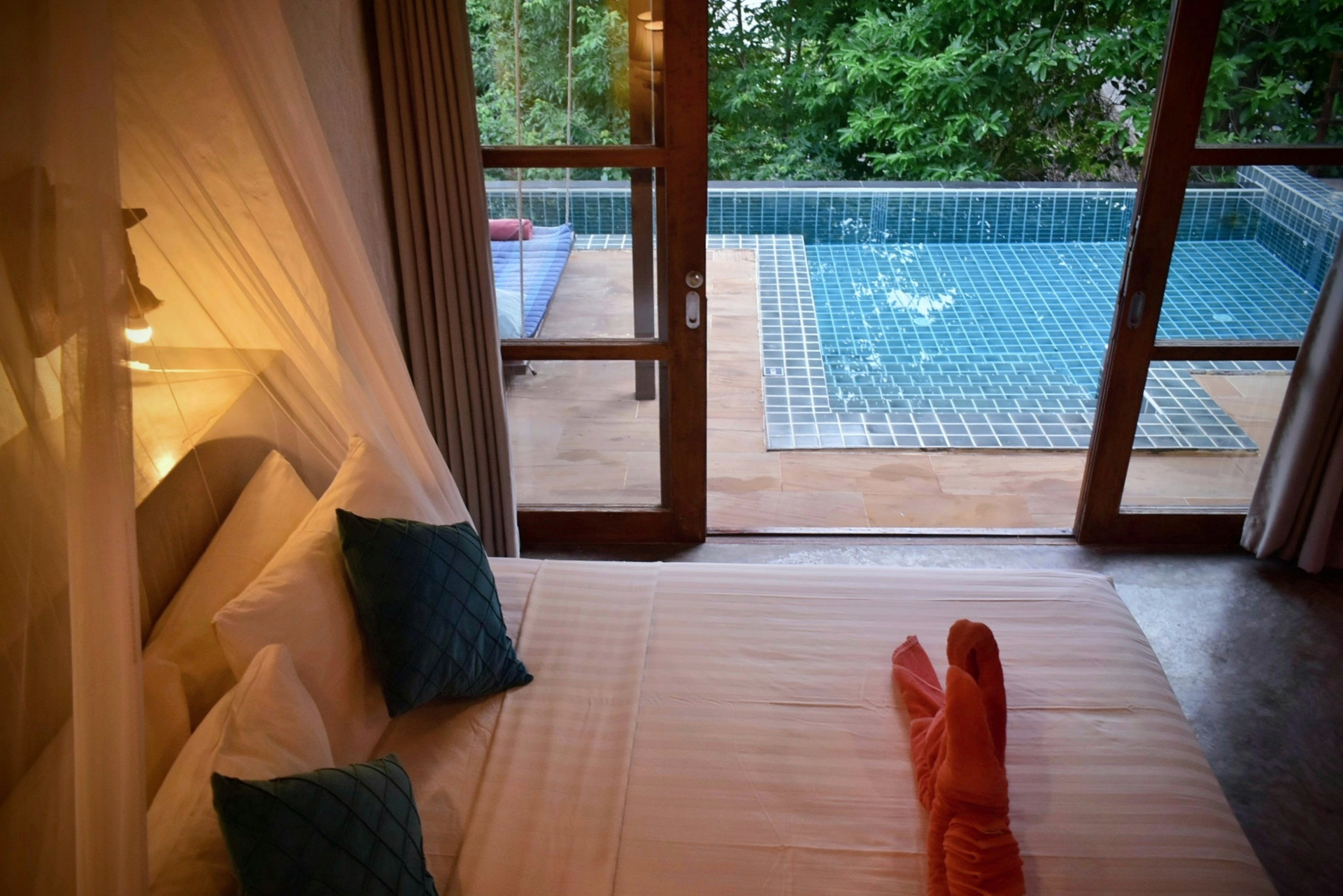 Bedroom opening onto a private plunge pool with garden view at The Fisherman's House